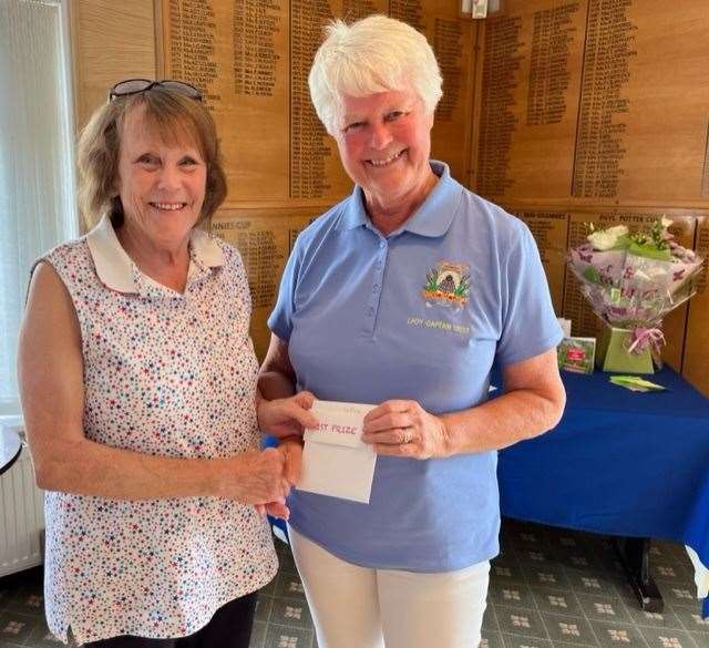 Penny Gilbert is presented with her prize by lady captain Margaret Butt (57726641)