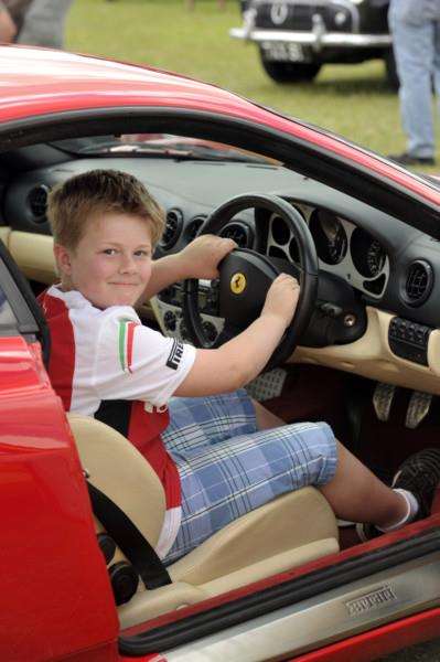 Samuel Fairbrother sits behind the wheel of a Ferrari at the Parson Drove Car, Bike and Trike Show.