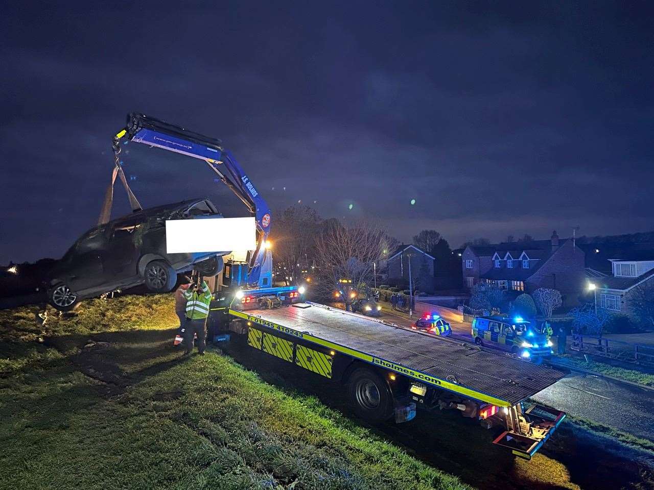 The car is recovered by specialist equipment from the river bank following the crash in Guyhirn.