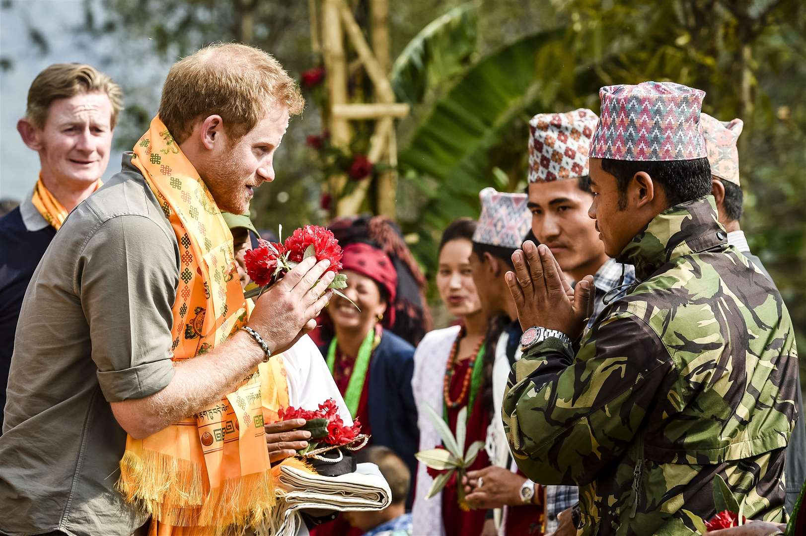 Harry gives a namaste greeting as he arrives at an earthquake-stricken village in Nepal in 2016 (Ben Birchall/PA)