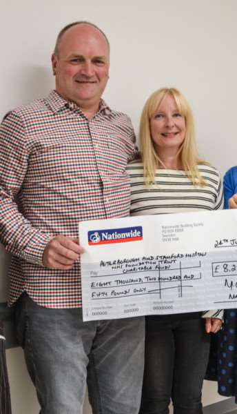 Mark Cross and his wife recently handed over the proceeds of last year's darts day.