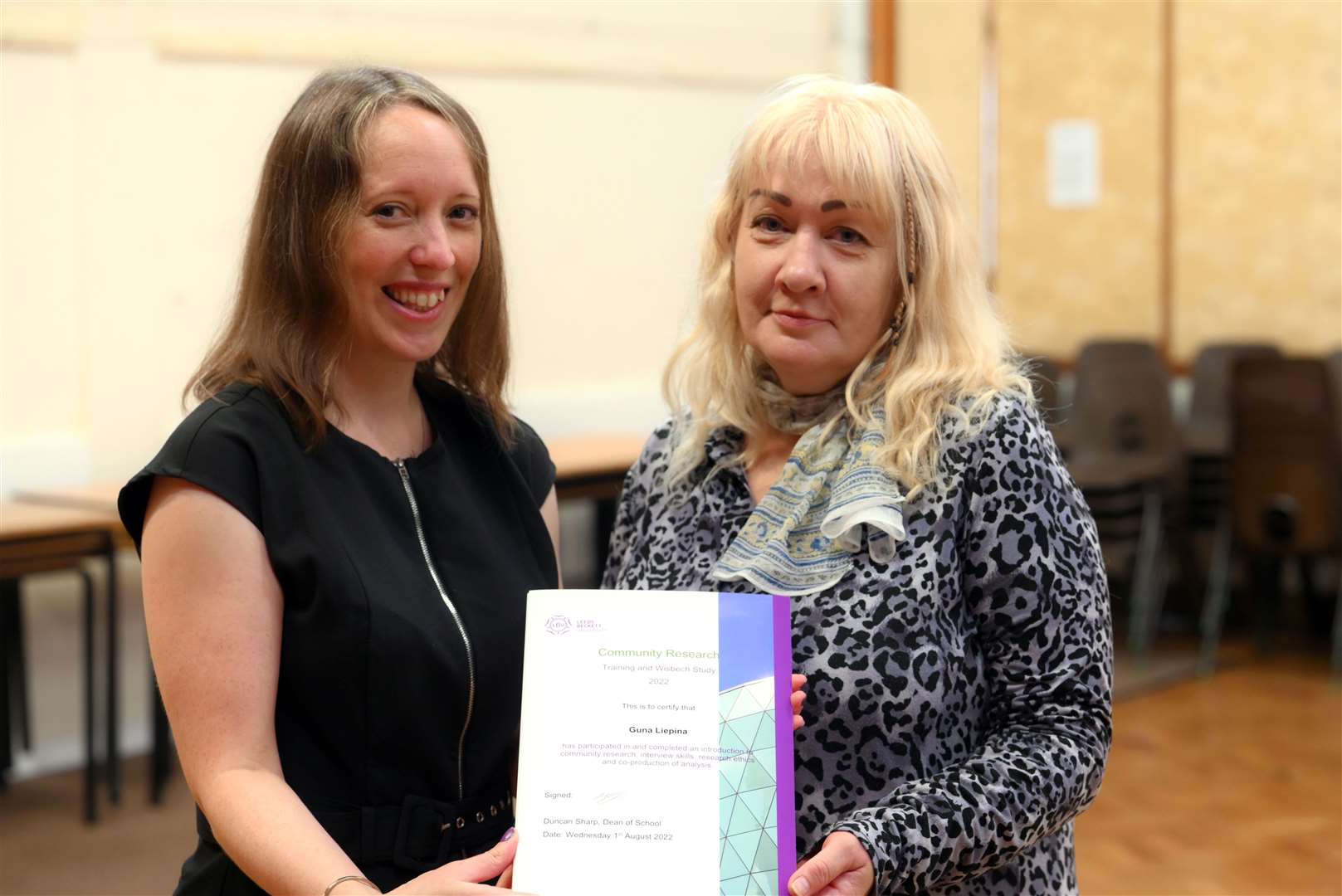 Guan Liepina receives her certificate from Susan Coan (left).