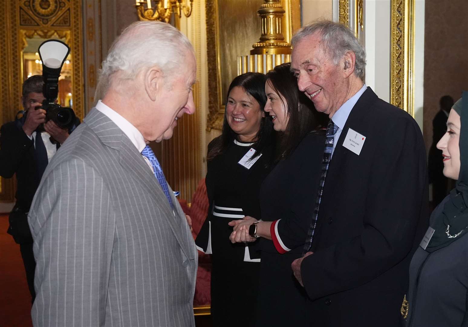 Charles speaks to Tony James, thought to be the oldest working journalist in the UK (Aaron Chown/PA)