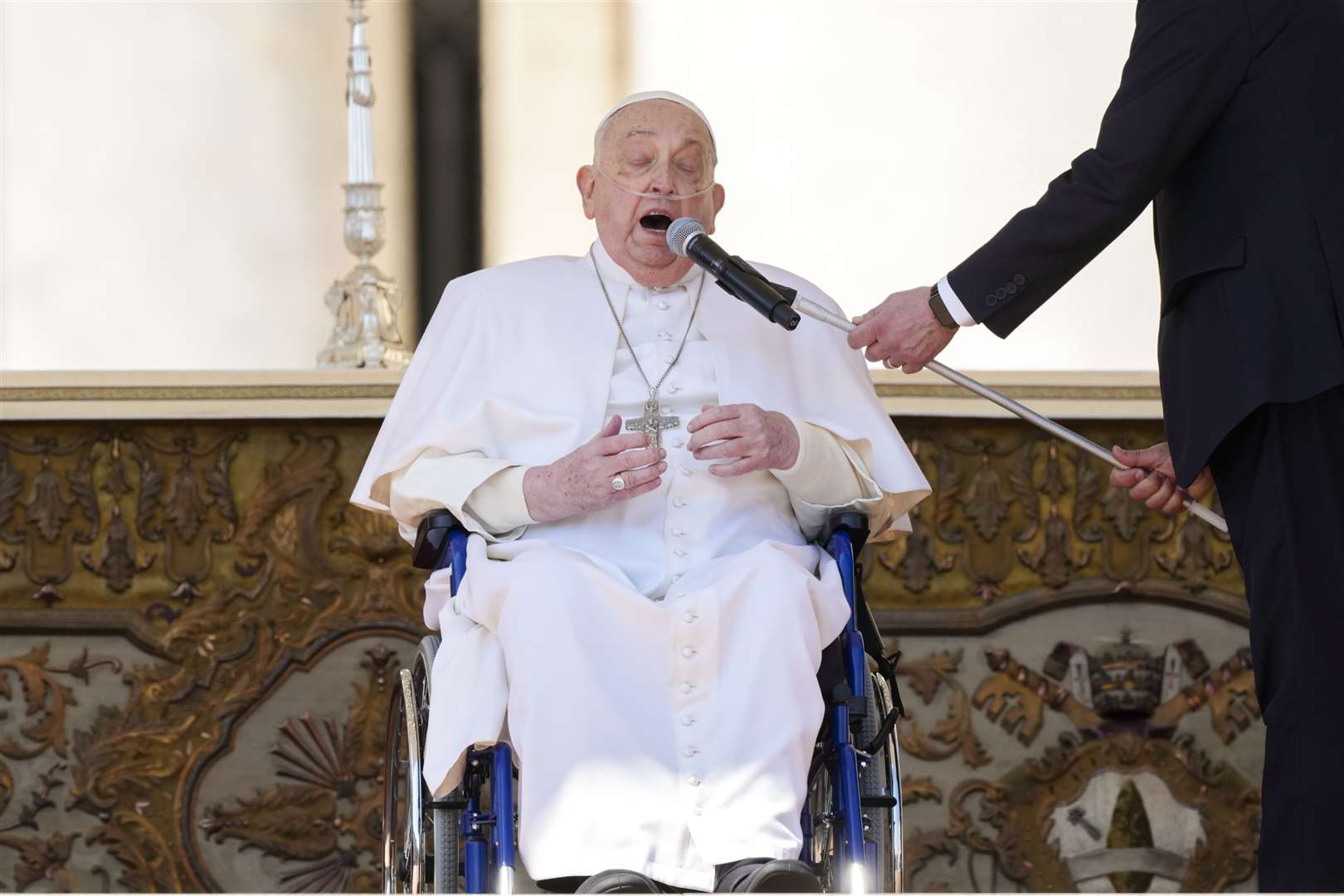 Pope Francis in a wheelchair speaks to faithful at the end of a mass in St Peter’s Square at The Vatican on Sunday (Andrew Medichini/AP)