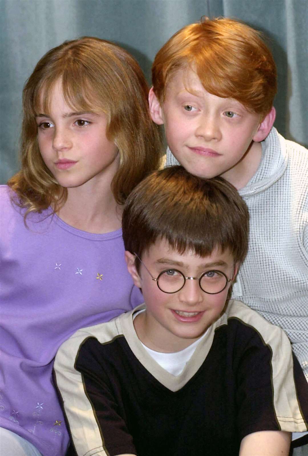Daniel Radcliffe (centre) with co-stars Rupert Grint (Ron Weasley) and Emma Watson (Hermione Granger) when they were cast more than two decades ago (PA)