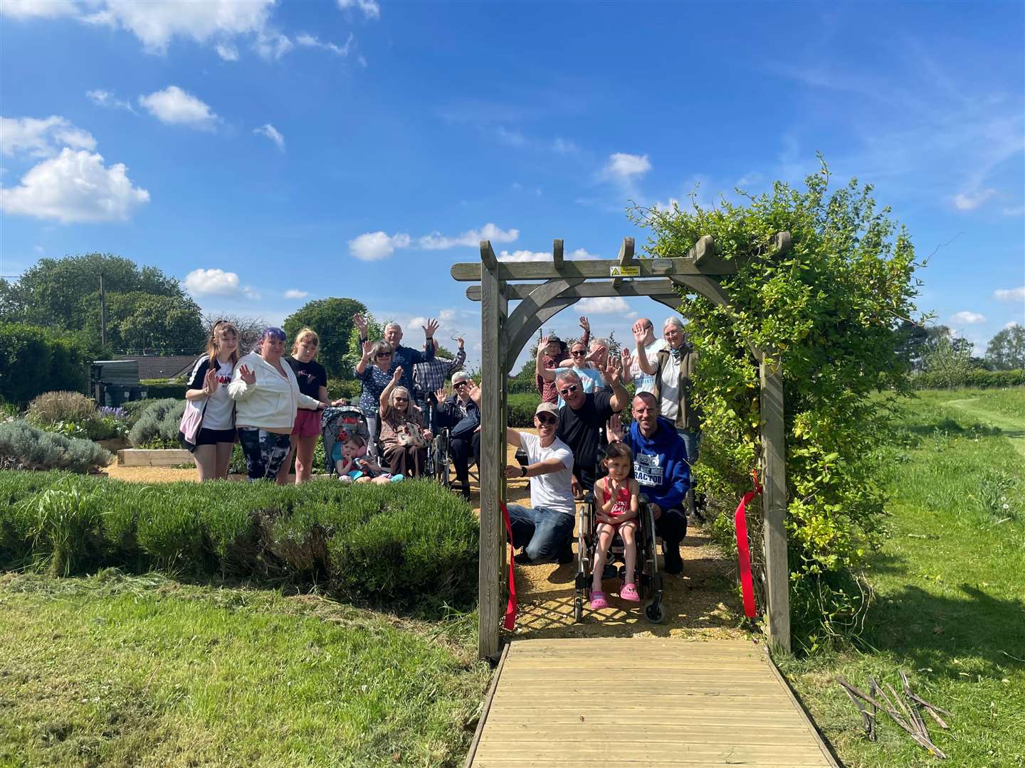 Celebrating the opening of the new wheelchair-friendly boardwalk at Sandgate Meadow Park, Welney, with young Angel pictured at the front