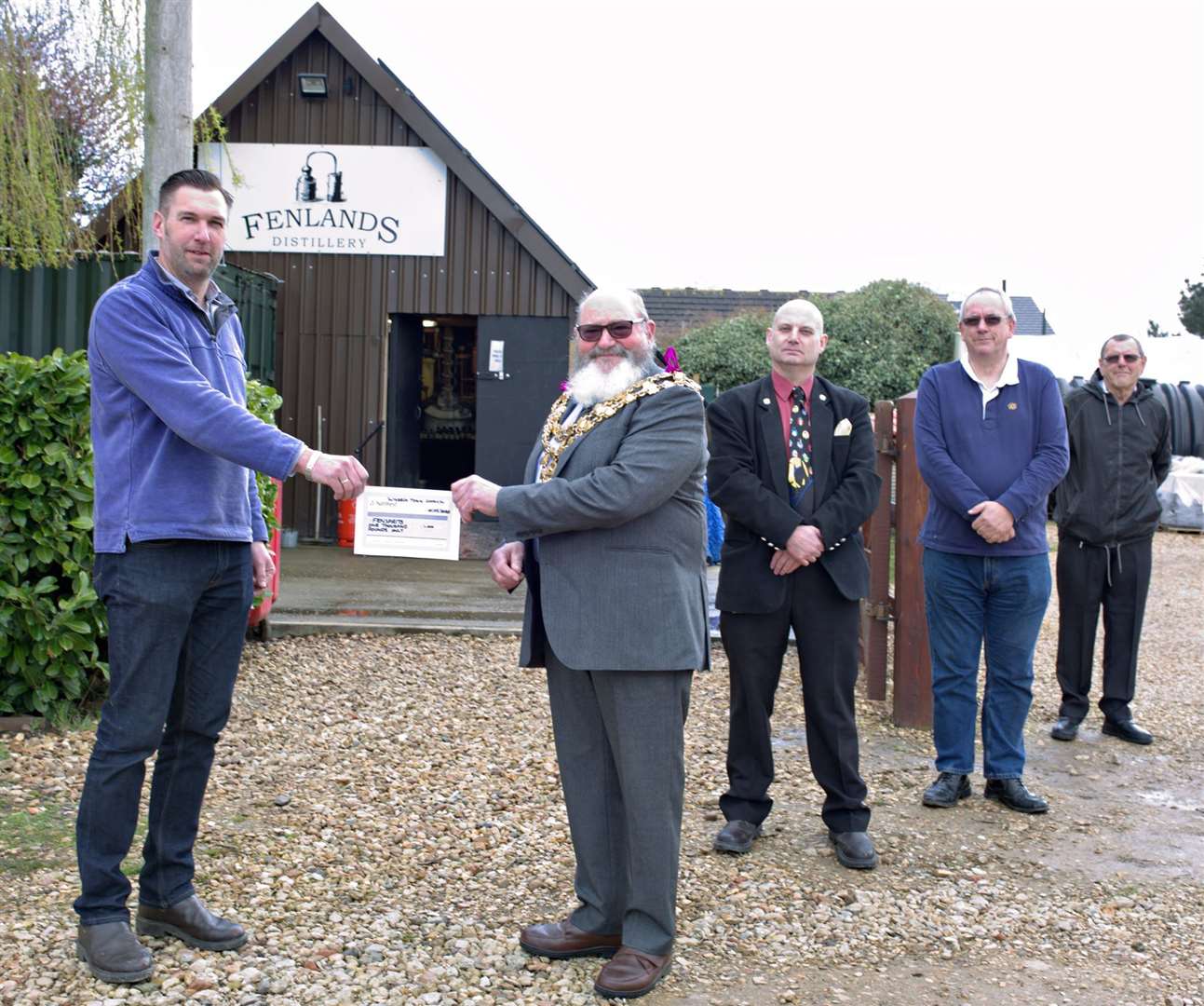 Wisbech mayor Michael Hill presents the cheque to Anthony Winterbourne with the cost of making hand sanitiser. (32046467)