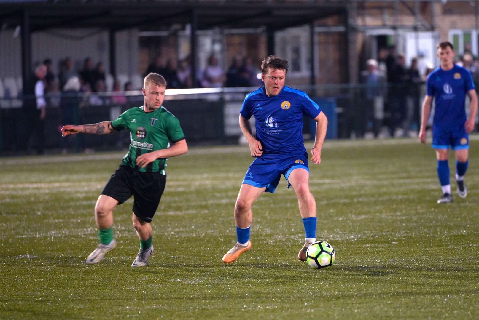 March (Blue) v Blackstones (Green and Black) in the final of the Hinchingbrooke Cup. March Town's Jack Saunders