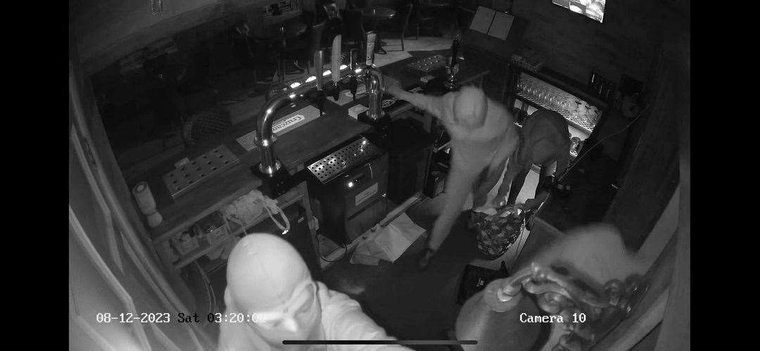 The burglars in action at Blues Bar and Restaurant.