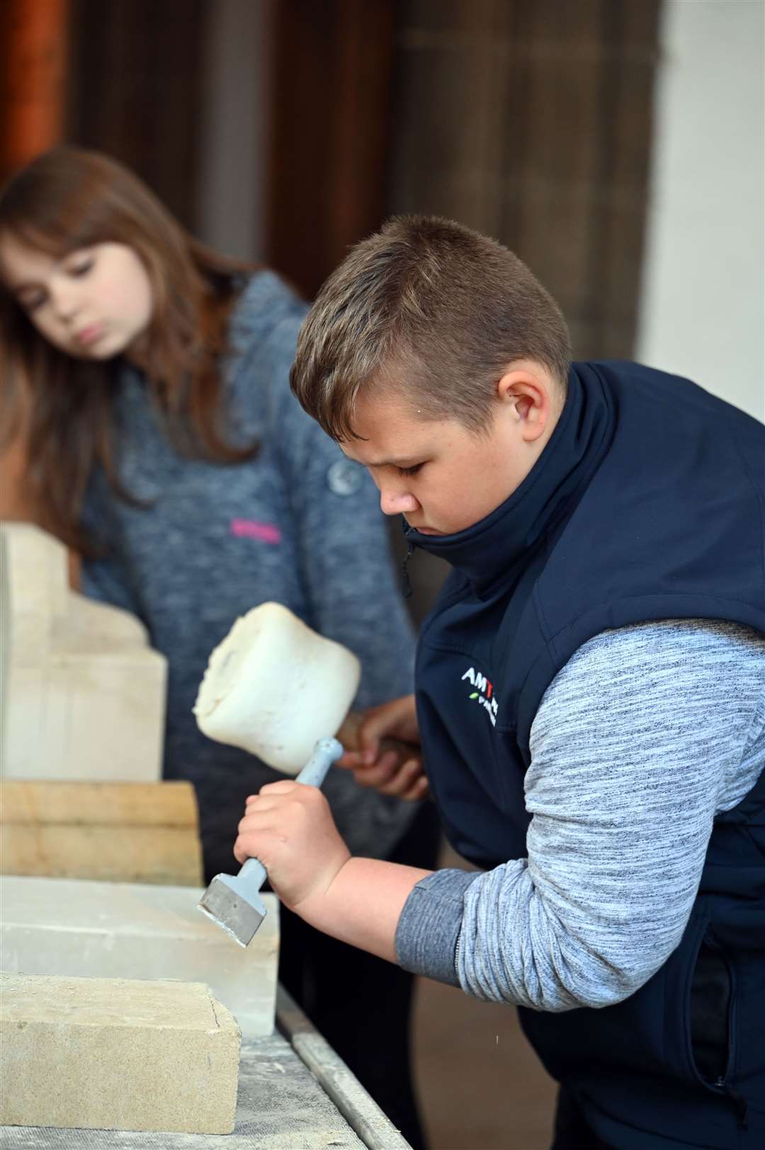 Pupils try their hand at stone masonry.