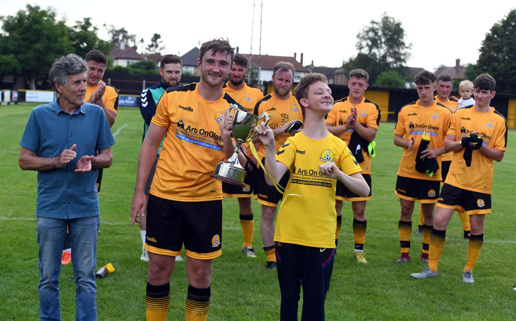 A young fan helps Max Mattless lift the BKD Trophy