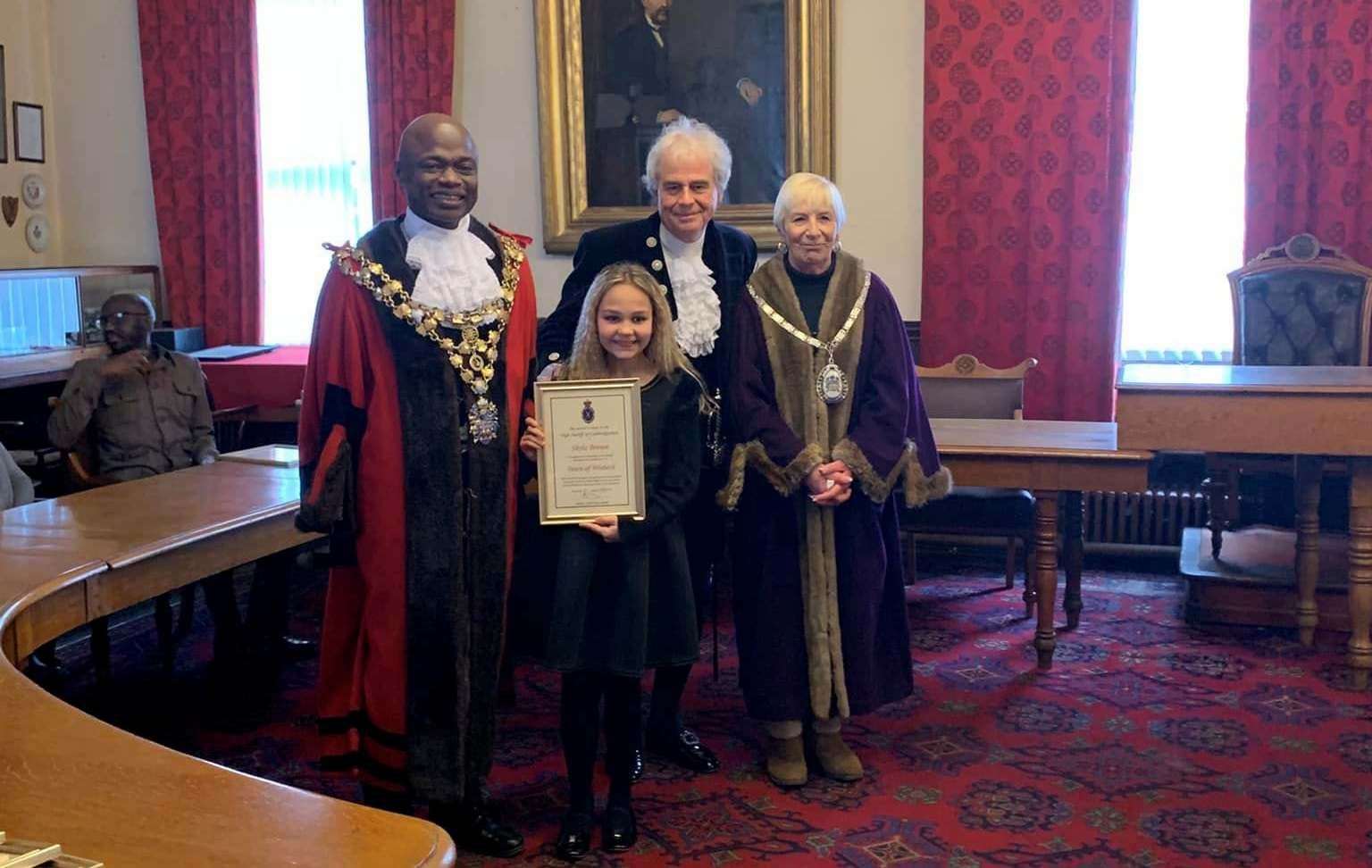 Shyla Brown proudly shows off her certificate pictured with mayor Cllr Sidney Imafidon, the High Sheriff, David Way, and deputy mayor Janet Tanfield