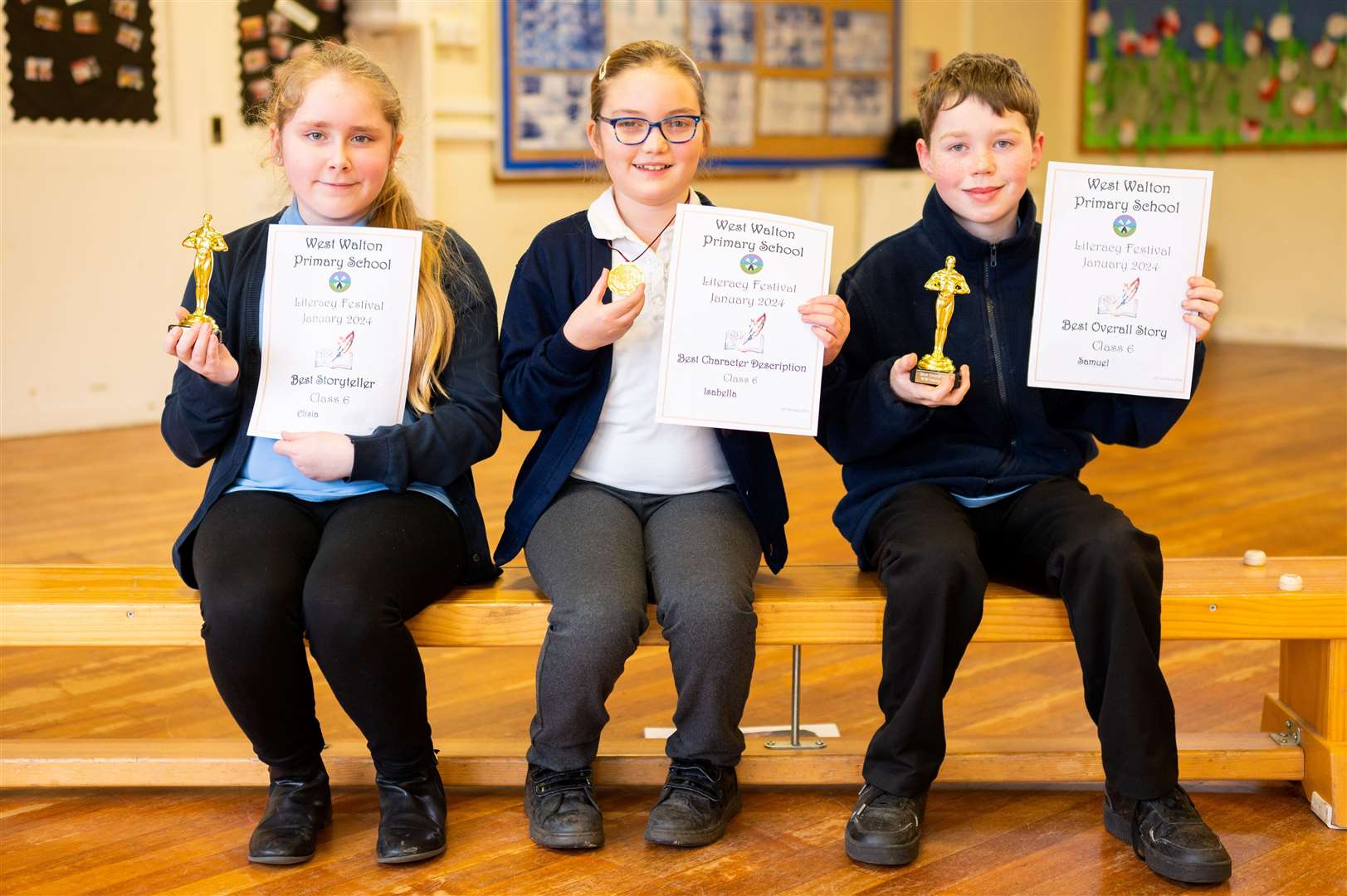 Class Six show off their certificates and statuettes.