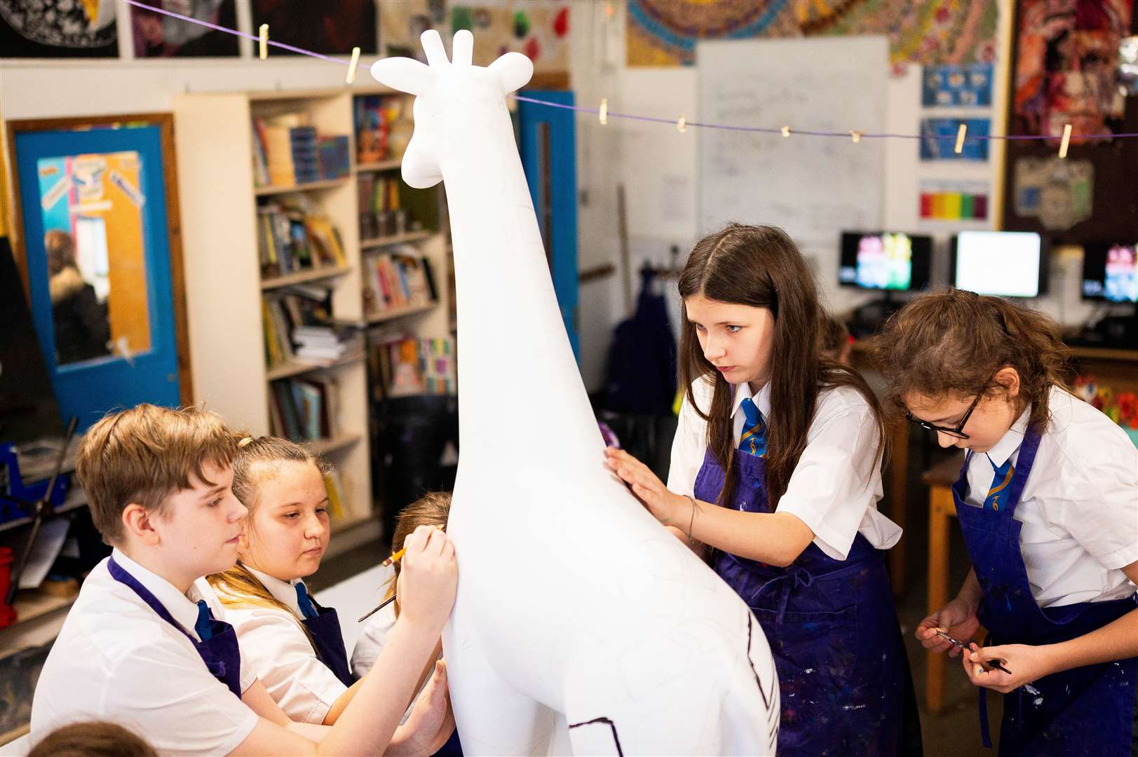 Students have designed and decorated a sculpture of Marsha the giraffe who will be part of the Cambridge Standing Tall exhibition in March. Photo: Barking Dog Media/Ian Burt.