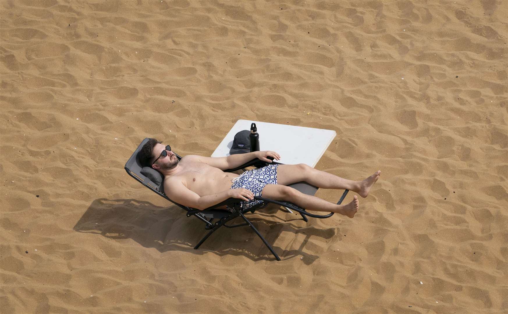 A man relaxes on the beach in Broadstairs, Kent (Gareth Fuller/PA)