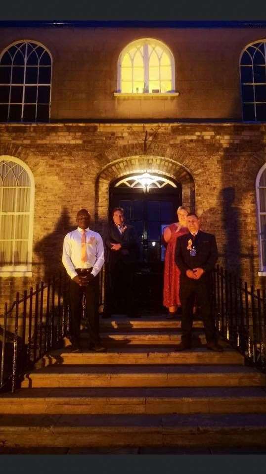 Businesses and buildings around Wisbech including the Castle went orange on Wednesday to mark National Battens Disease Day. From left: Councillors Sidney Imafidon, Steve Tierney and Sam Hoy with mayor Andrew Lynn.