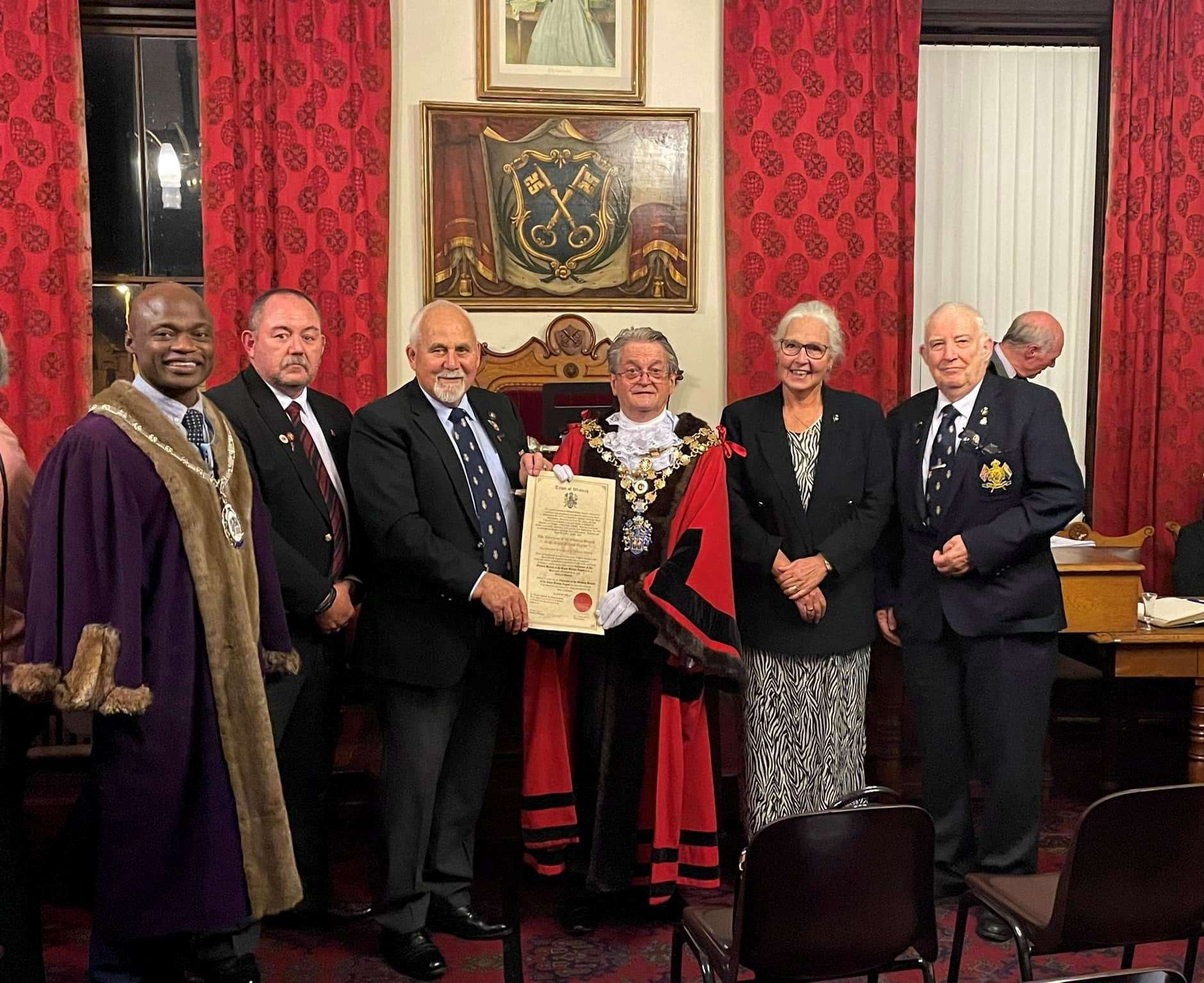 Toby North and members of the Wisbech Royal British Legion pictured with the mayor Peter Human, deputy mayor Sidney Imafidon and the certificate.
