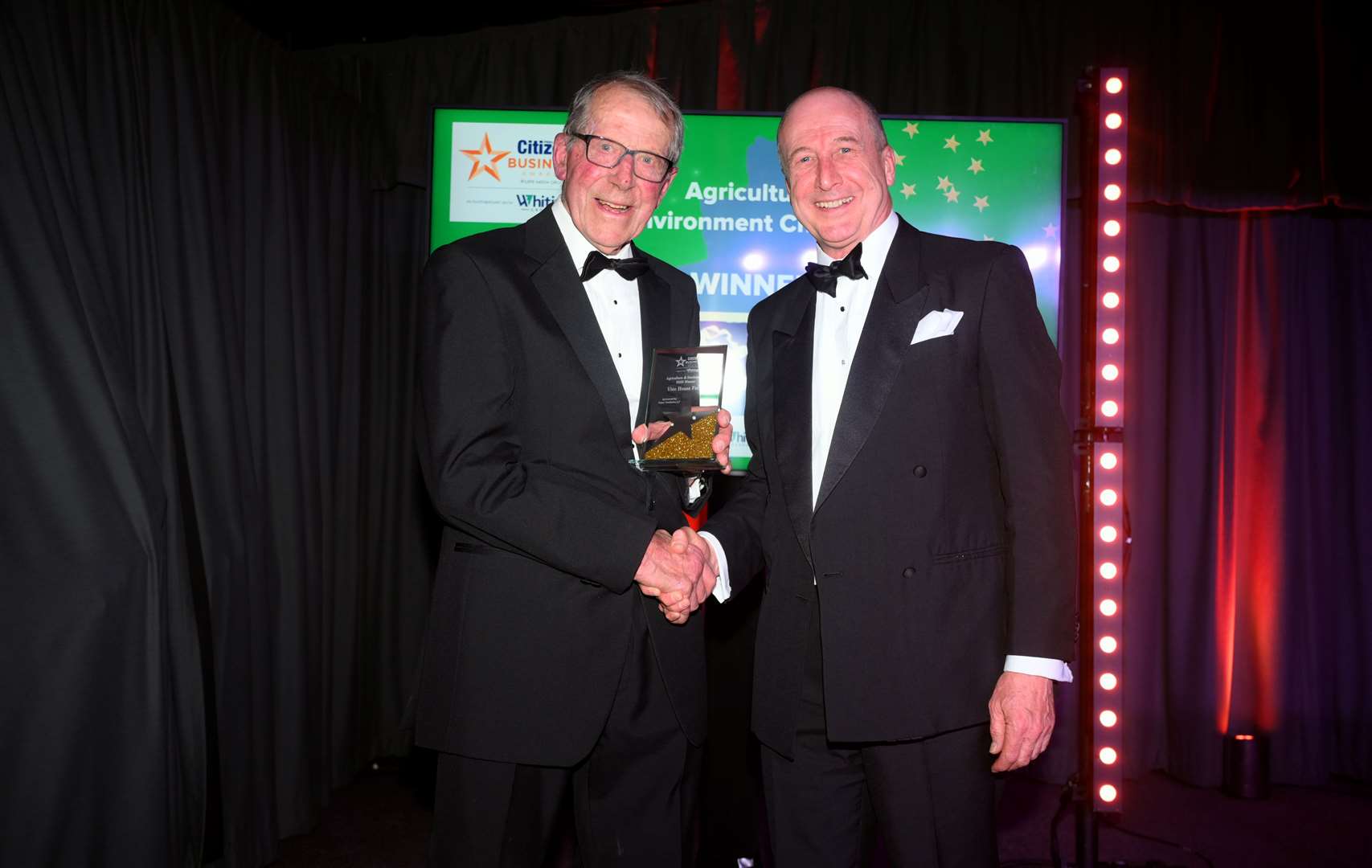 Fenland Citizen Business Awards 2025 Agriculture and Environment Champion winner Nicholas Watts (left) of Vine House Farm received his award from Tony Cheetham of category sponsor Fraser Dawbarns