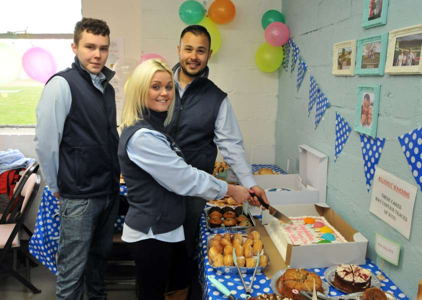 Shane Tilbrook (left), Aaron Heading and Natasha Jones cut a cake to celebrate the Priory's official opening. Photo by Tim Wilson.