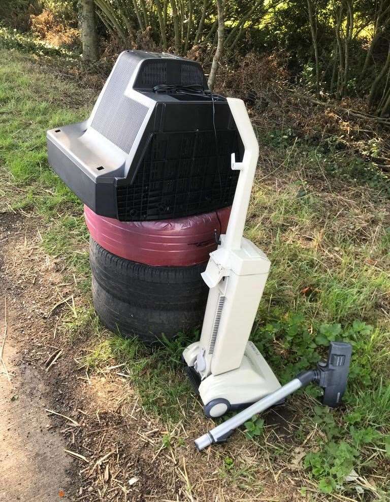 Andy and Deanne report fly-tipping such as this where an old television and hoover has been dumped on a layby tyre bin