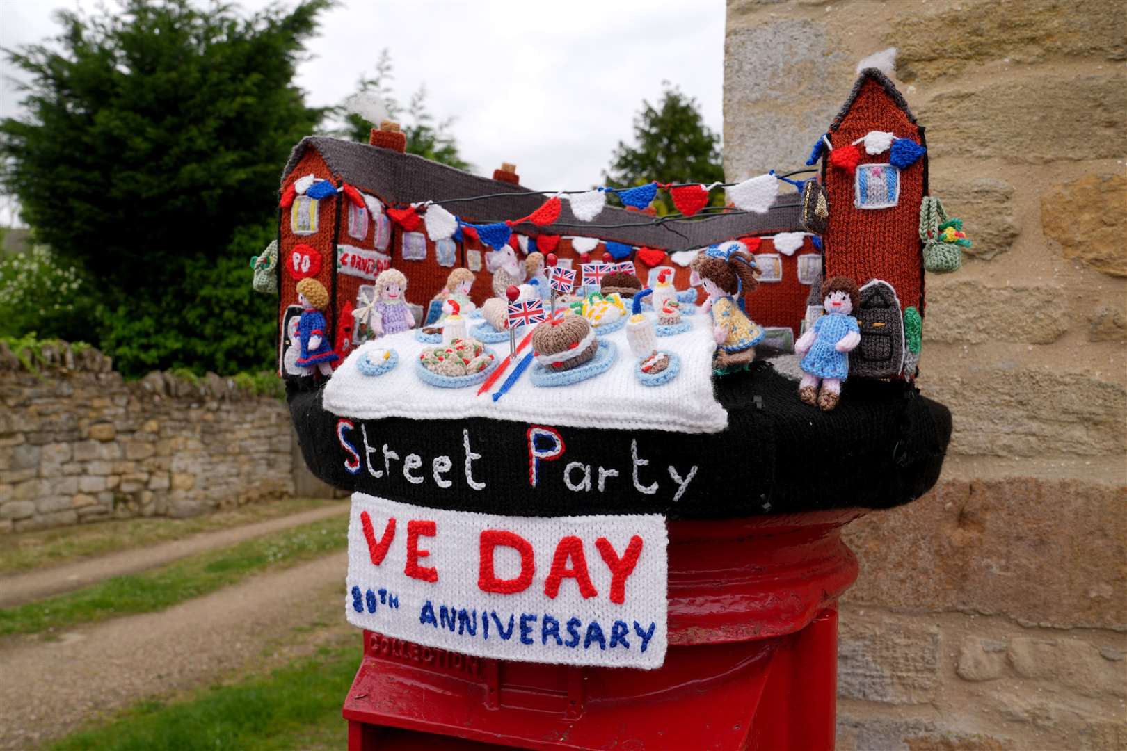 A knitted postbox topper in Tallington, Lincolnshire, to celebrate the 80th anniversary of VE Day (Joe Giddens/PA)