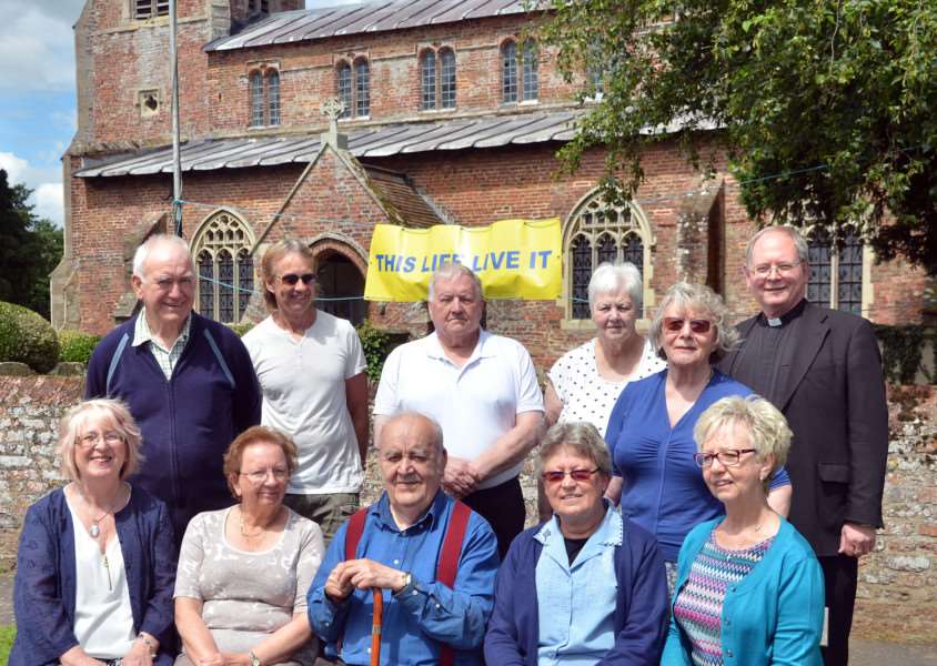 CHURCH CASH I: Parish priest Father Jonathan Sibley (back right) churchwardens and church council members outside St Nicholas Church, Lutton. Photo by Tim Wilson.
