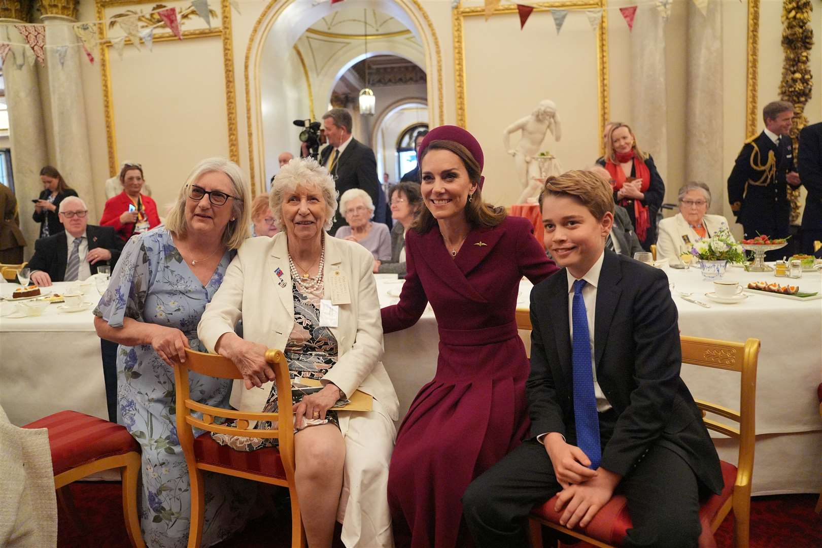 Kate and son George with tea party guests (Yui Mok/PA)