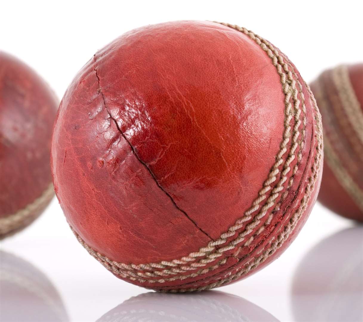 Three red leather cricket balls isolated on white (11811950)