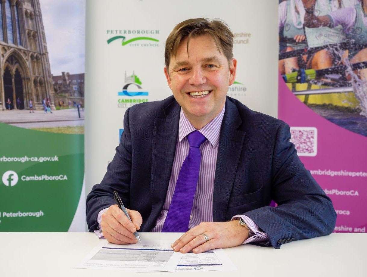 Mayor Dr Nik Johnson signing the decision notice confirming he has chosen franchising for Cambridgeshire and Peterborough's bus network. Picture: Combined Authority.