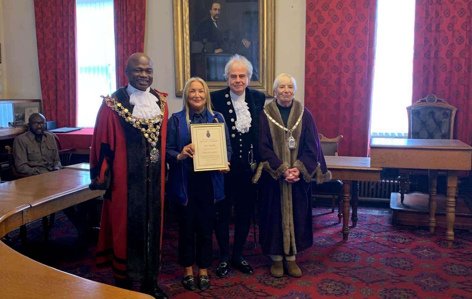 Julie Bushby Tesco Community Champion with her certificate pictured with mayor Cllr Sidney Imafidon, the High Sheriff, David Way, and deputy mayor Janet Tanfield