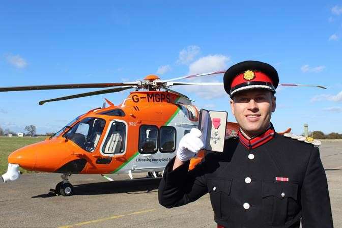 aryl Brown MBE DL with his MBE in front of the Magpas Air Ambulance. (55547593)