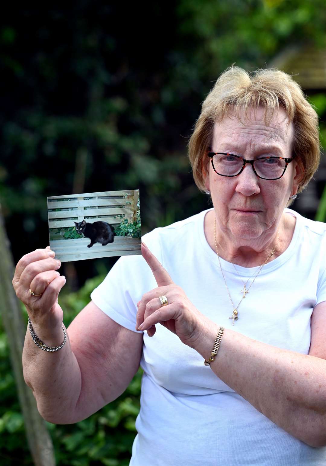 Pam Bower with a photo of her cat Simba.