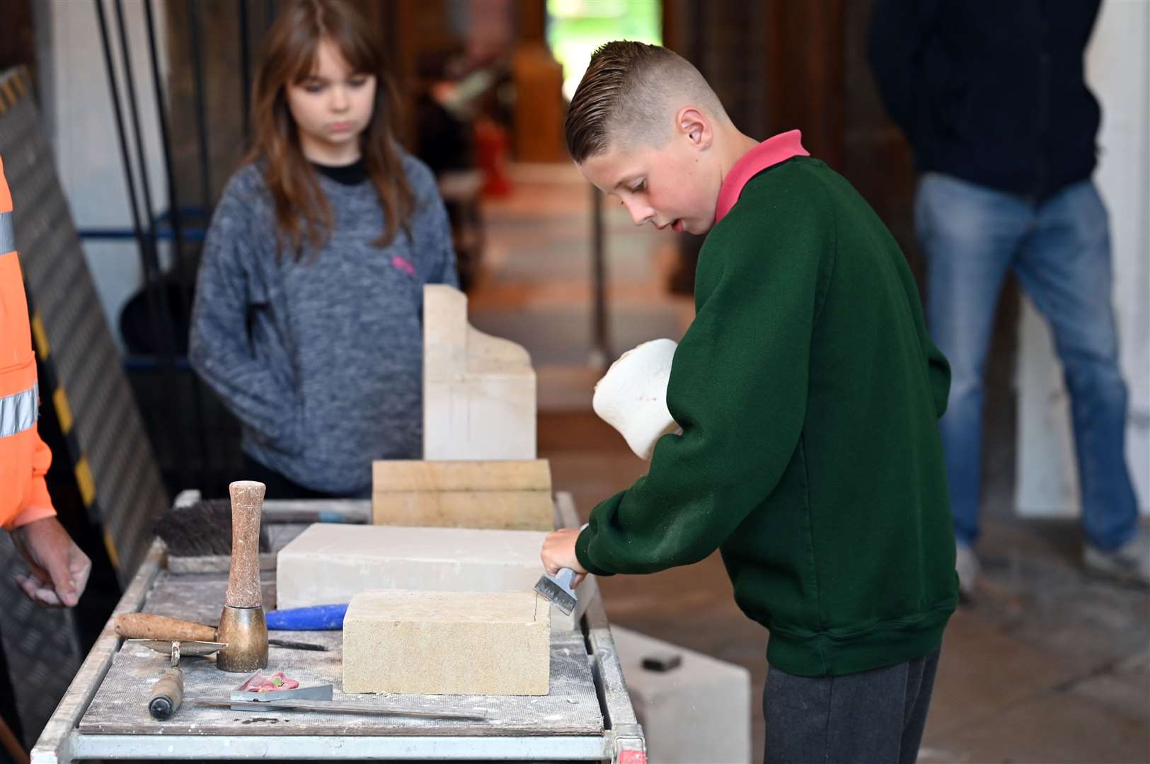 Pupils try their hand at stone masonry.