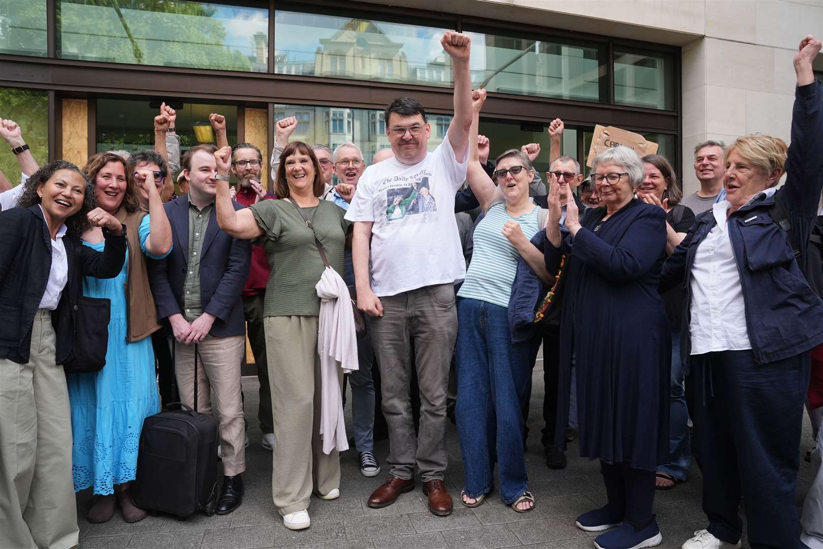 Graham Linehan, centre, posed with supporters outside Westminster Magistrates’ Court (Lucy North/PA)