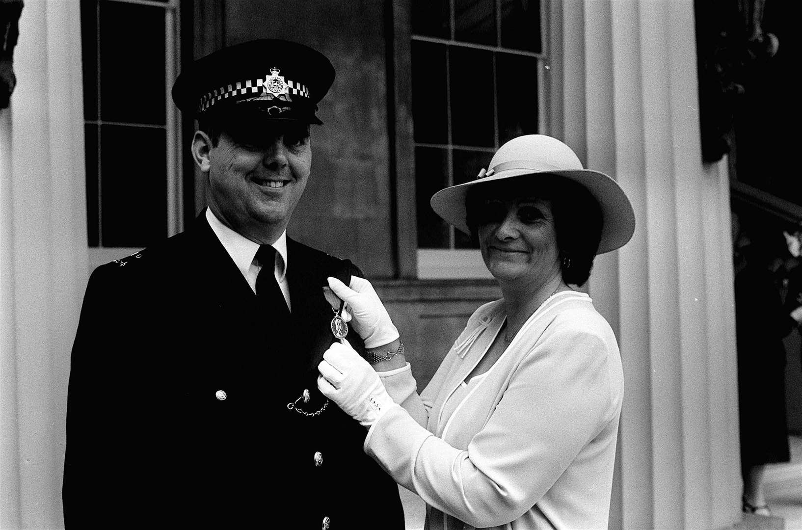 Pc Trevor Lock with his wife Doreen and his George Medal at Buckingham Palace (PA)
