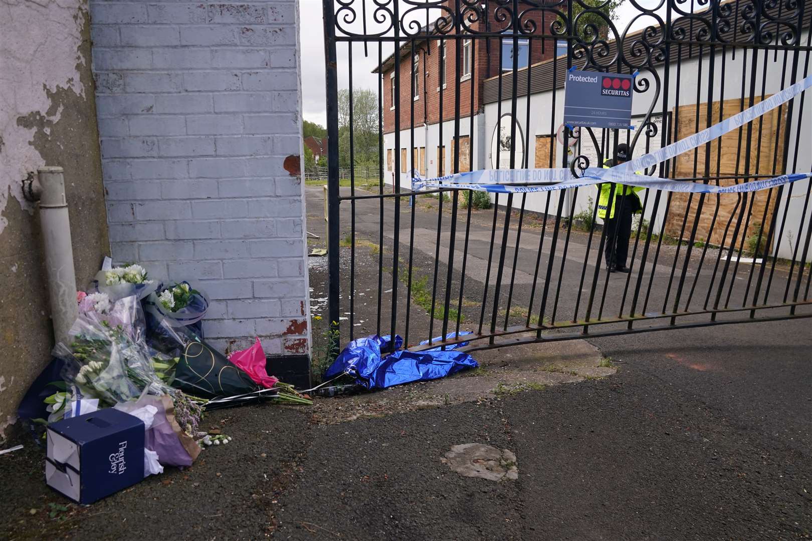 Floral tributes left at the scene (Owen Humphreys/PA)