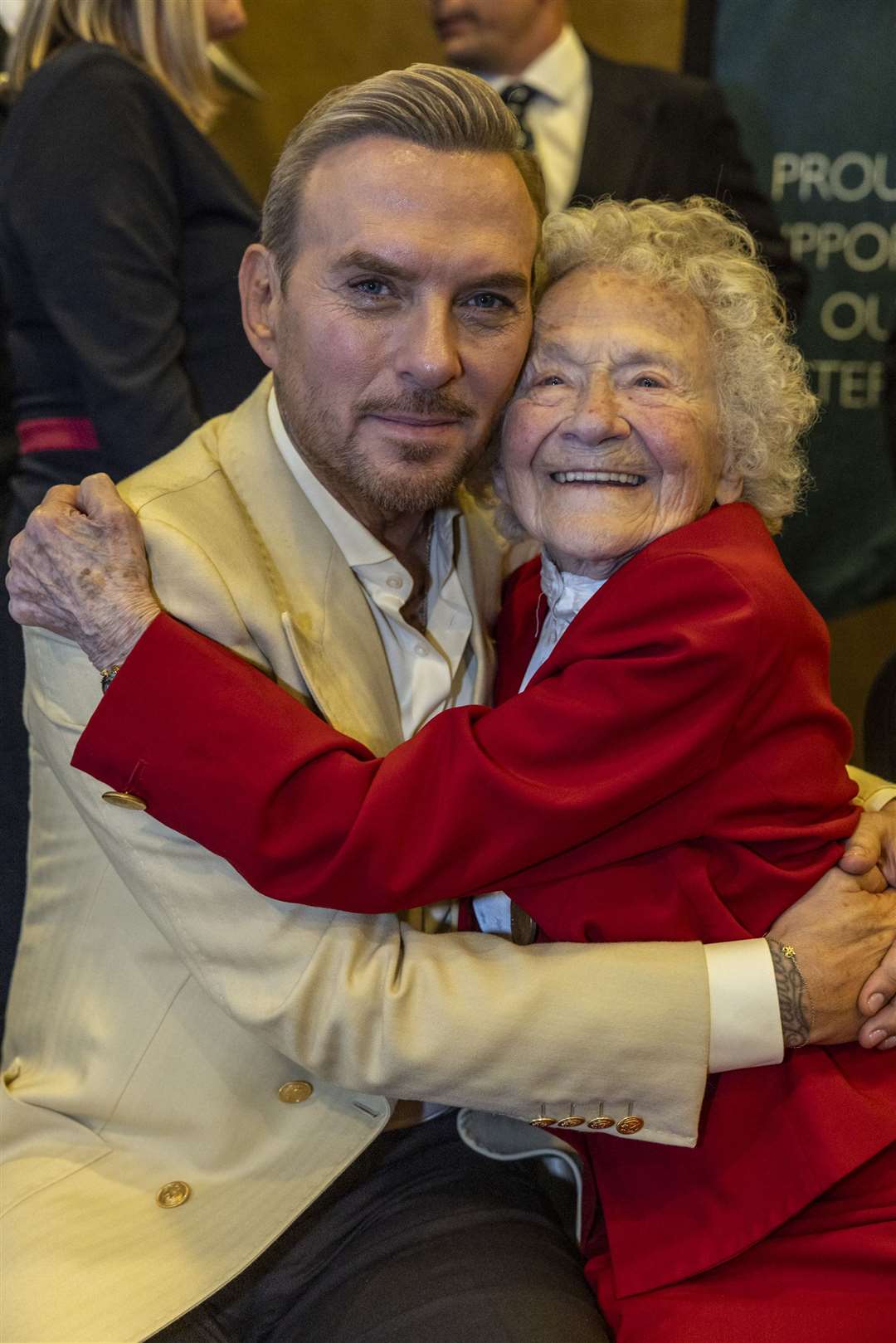 Second World War veteran Dorothea Barron, 100, gives Matt Goss a hug (Schmooly/The Not Forgotten/PA)