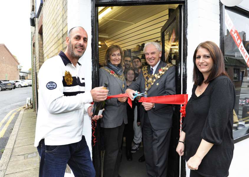 Wisbech Mayor and Mayoress David and Judy Hodgson, officially open Fens Menswear Shop in Wisbech, they are with owners Andy Nicolaou (front left) and Penny Nicolaou (front right), along with other family and friends. ANL-151030-175141009