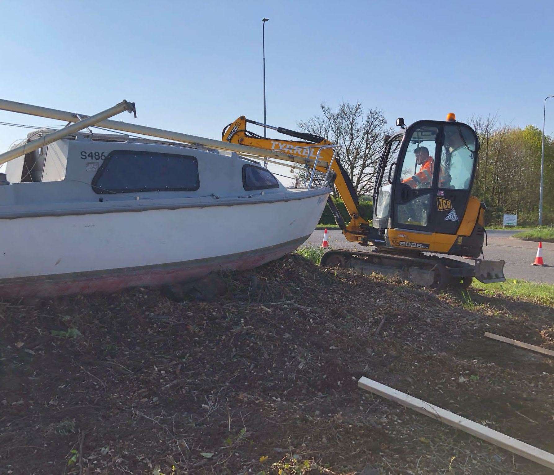 A digger helps to clear the roundabout for the boat