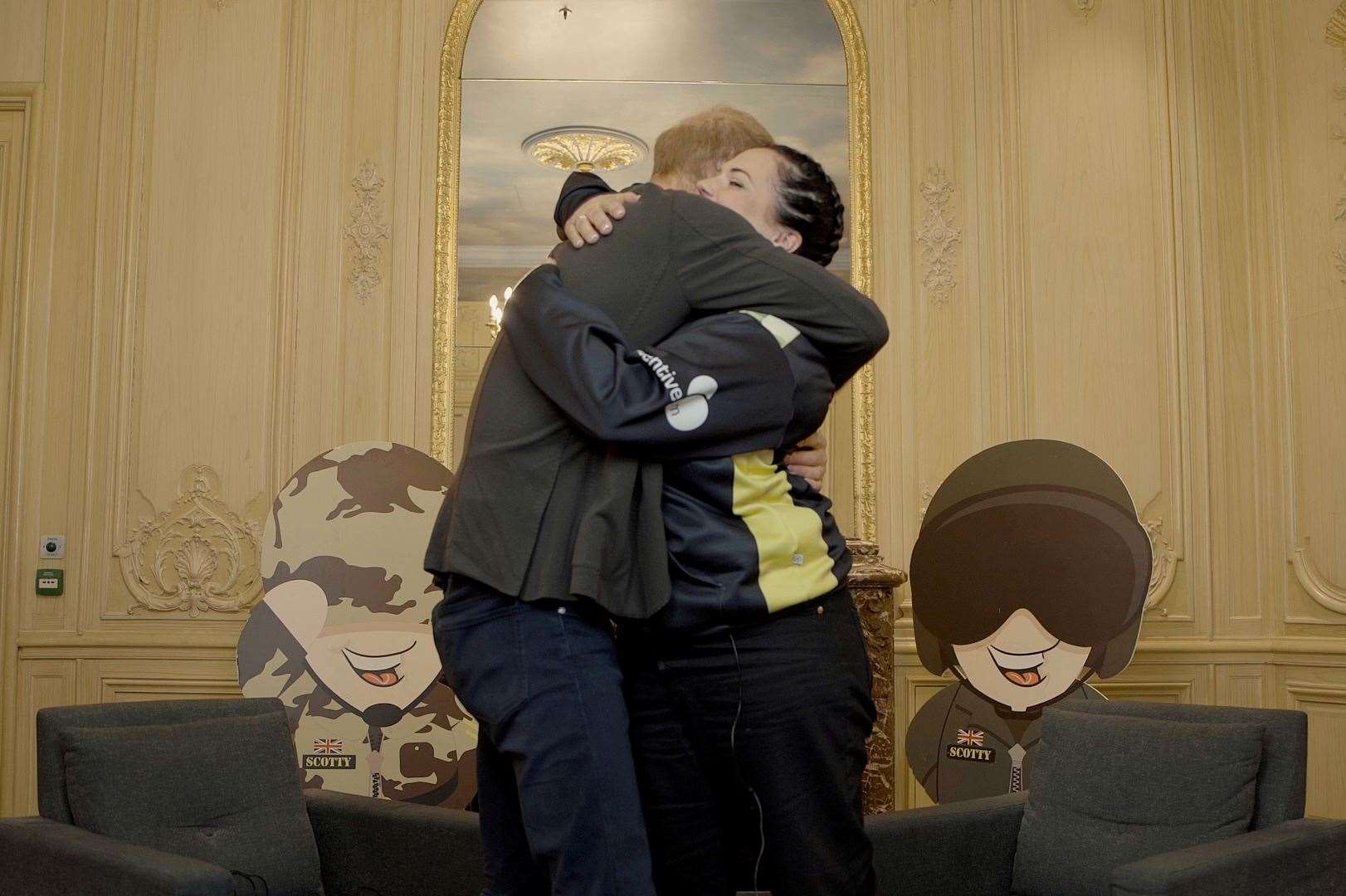 Prince Harry gives Nikki Scott a comforting hug. Picture: Scotty's Little Soldiers