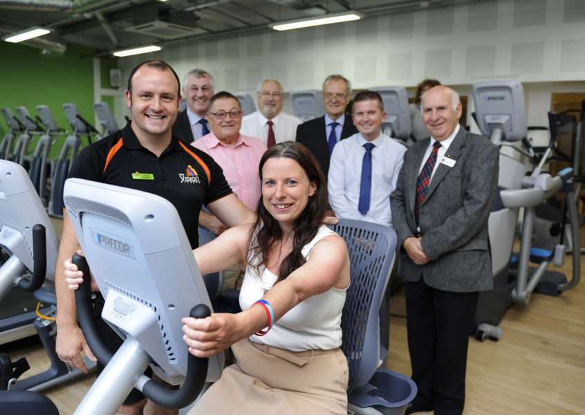 Official opening of the George Campbell Centre in March, Michelle Tanfield (cabinet member) in the the new fitness area, with Andy Cornwell (left) Duty Centre Manager.'Also in pic District and Town Council Members and other guests at the opening. ANL-150722-090137009