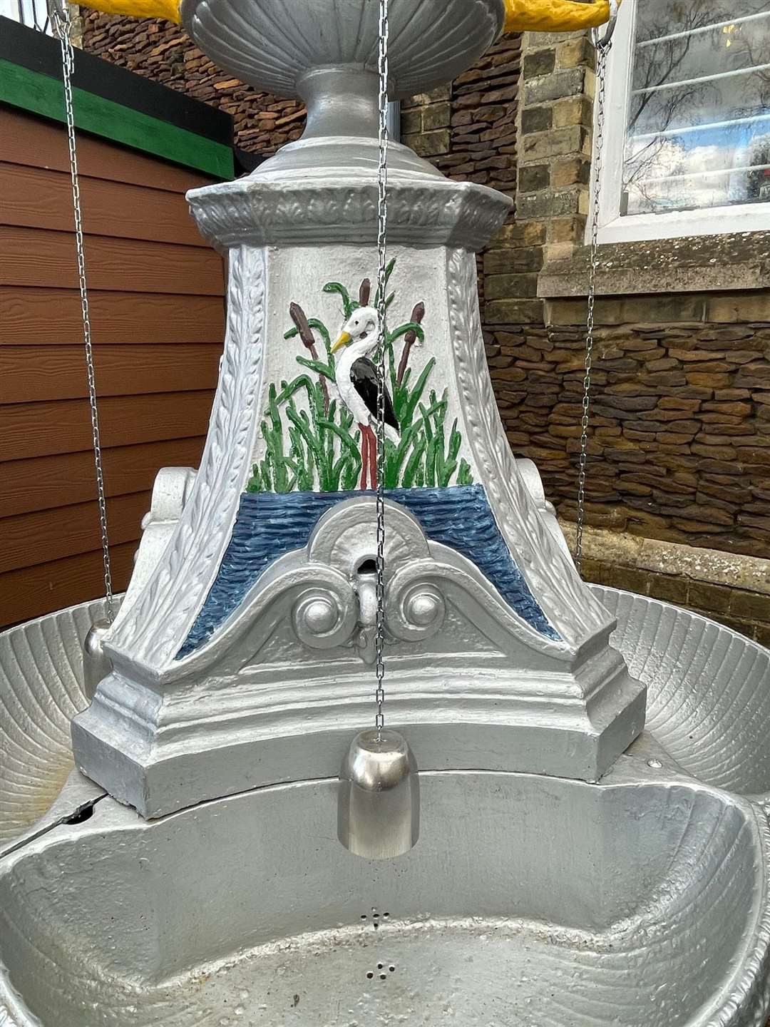 The drinking fountain has been restored to its former glory complete with drinking cups