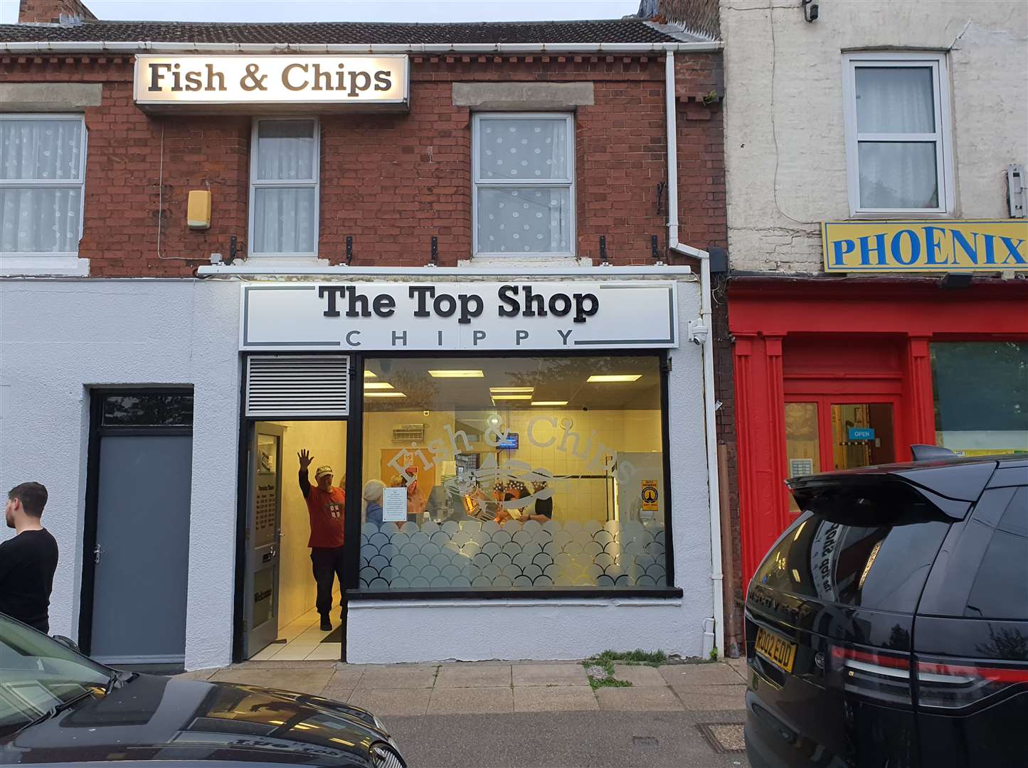 A happy customer gives the camera a wave