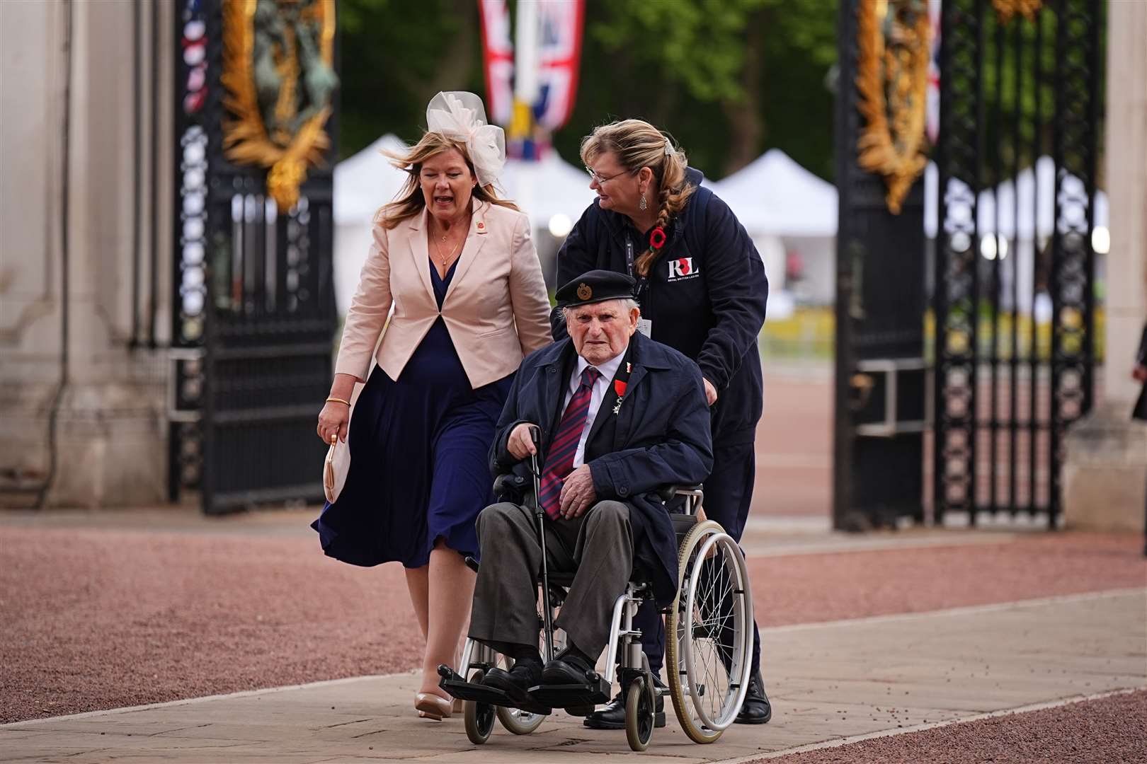 Second World War veteran Alfred Littlefield is escorted into Buckingham Palace following the military procession (Aaron Chown/PA)
