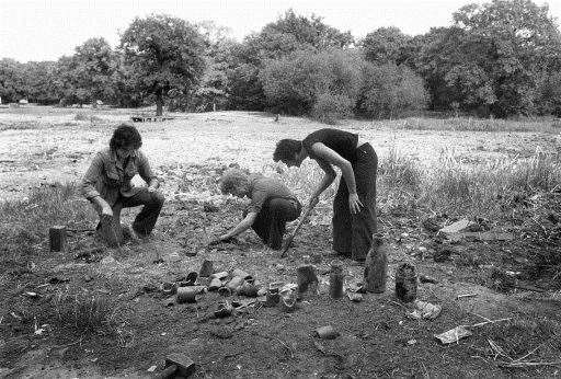 With fishing and other water activities out the question, teenagers in Epping Forest dig for old bottles in August 1976. Picture: PA/PA Archive.