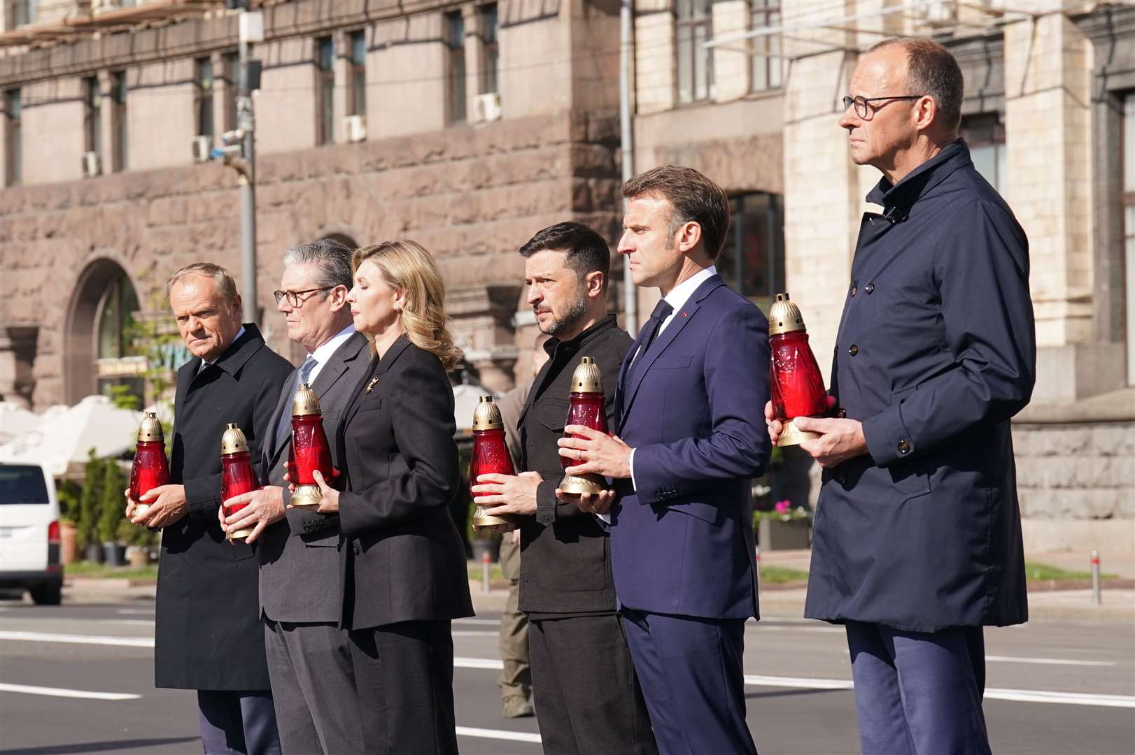 The leaders place candles at the memorial in Maidan Square (Stefan Rousseau/PA)