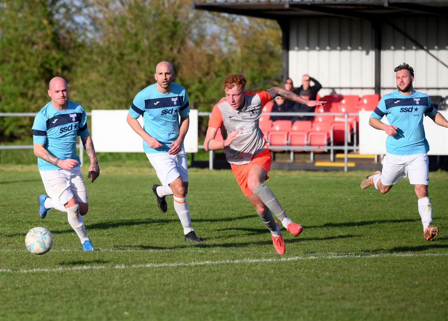 Parson Drove (grey and orange) v Holland (blue). Matteo Perkins hits the post.