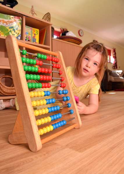 Ella Higgins gets down to the sums on Cinder Ash Pre-School's new floor. Photo by Tim Wilson.''ANL-160825-140425001