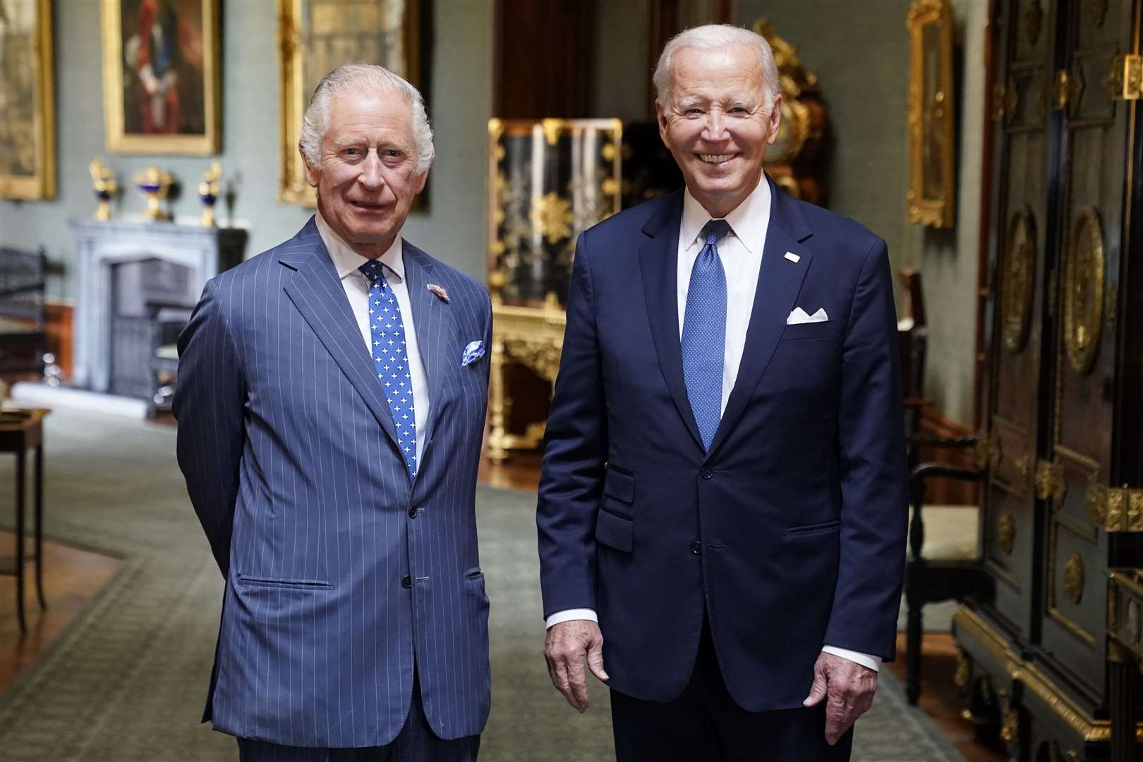 The King and with then-US president Joe Biden in the Grand Corridor at Windsor Castle in 2023 (Andrew Matthews/PA)