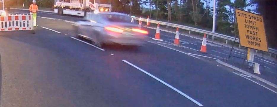 A motorist has been banned from driving after smashing through a barrier on a closed-off section of carriageway and sending road workers running for cover. Picture: National Highways